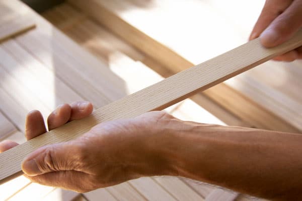 hand selecting individual samina slats